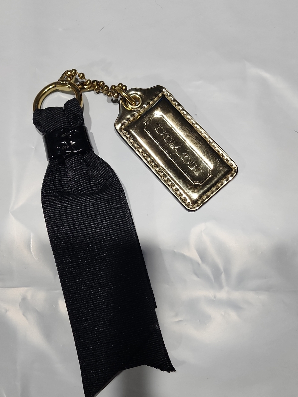 COACH Gold-Tone Logo Tag Key Ring with Black Ribbon
